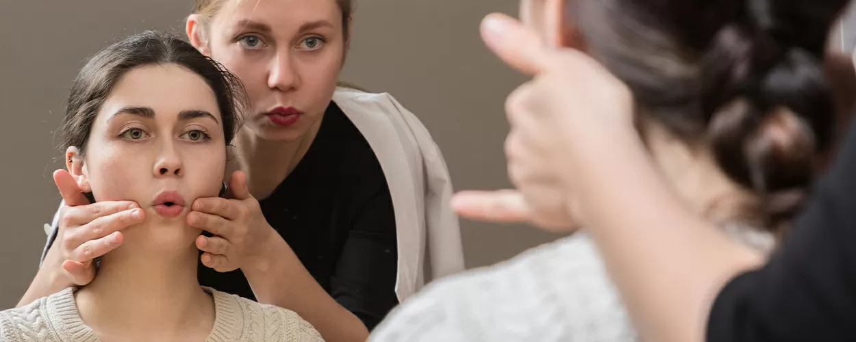 Therapist with an in home patient working on mouth exercises